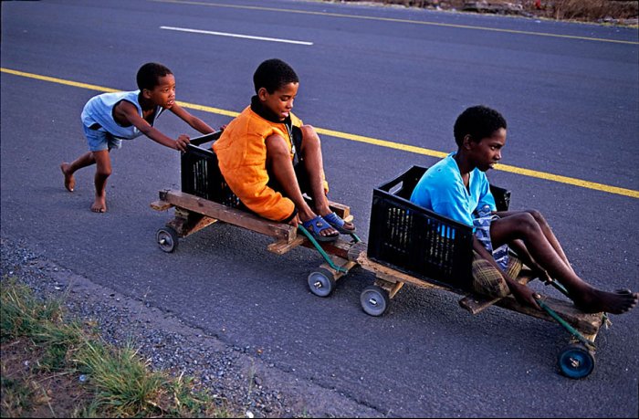 South Africa - Rovos Rail - Black Kids playing with a wooden train